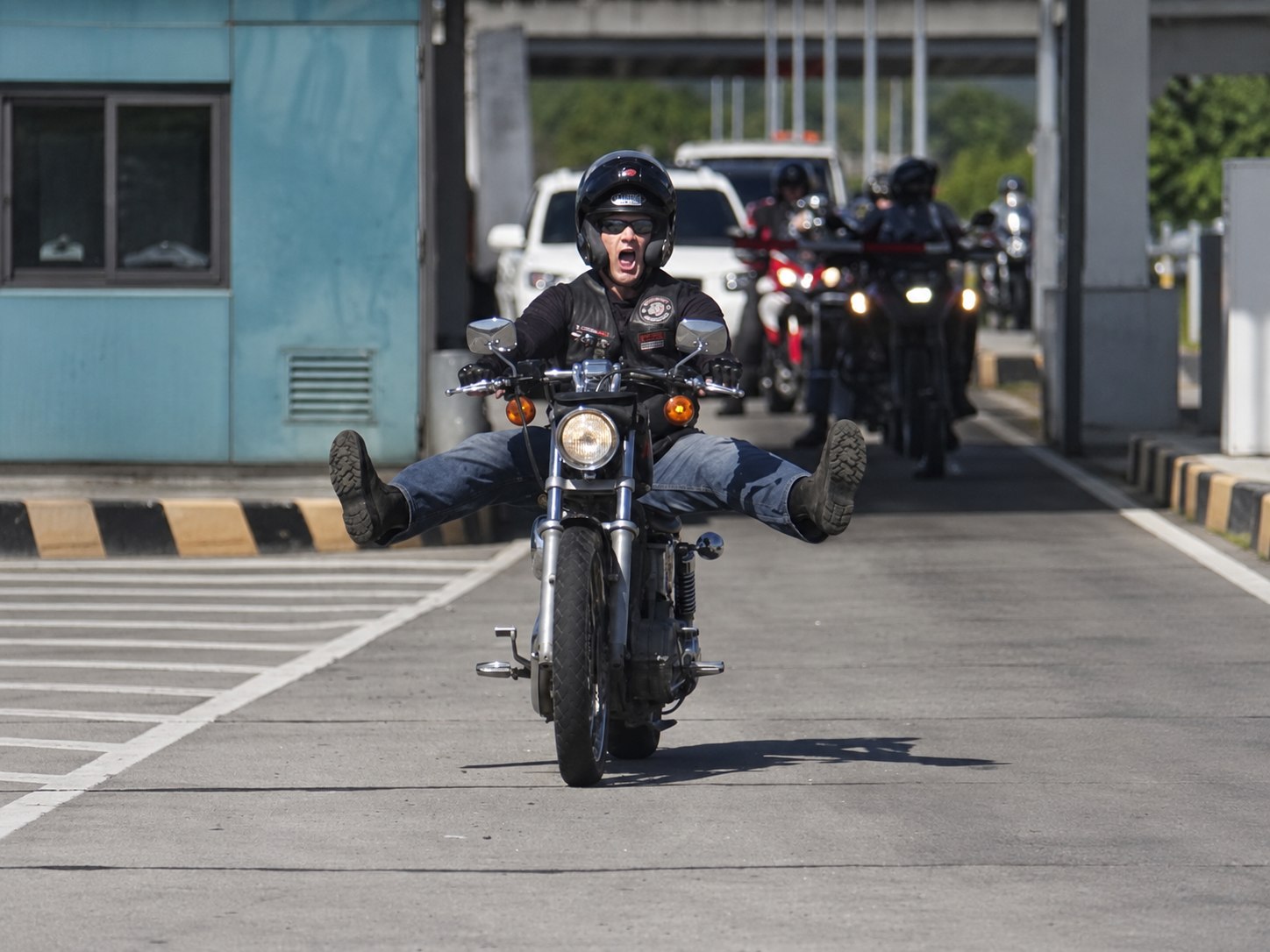 Scott riding a motorcycle through city traffic